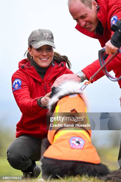 Catherine, Princess of Wales and Prince William, Prince of Wales meet with a Search Dog on the Mountain Rescue Team during a visit to Central Beacons...