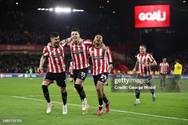 Anel Ahmedhodzic of Sheffield United celebrates with teammates John Egan and Iliman Ndiaye after scoring the team's second goal during the Sky Bet...