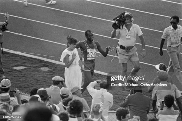 American athlete Edwin Moses is congratulated by his wife, Myrella, after winning the final of the men's 400 metres hurdles event of the 1984 Summer...