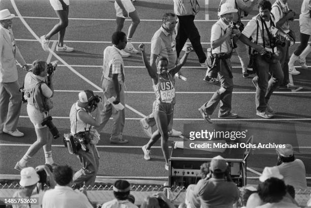 American athlete Evelyn Ashford celebrates after winning the final of the women's 100 metre event at the 1984 Summer Olympics, held at the Los...