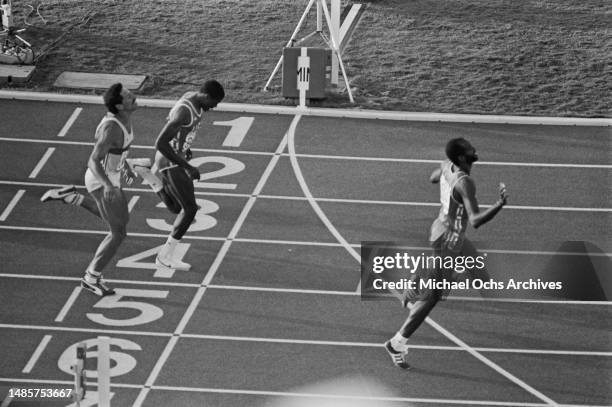 German athlete Harald Schmid finishes behind American athlete Danny Harris, and the winner, American athlete Edwin Moses, in the final of the men's...