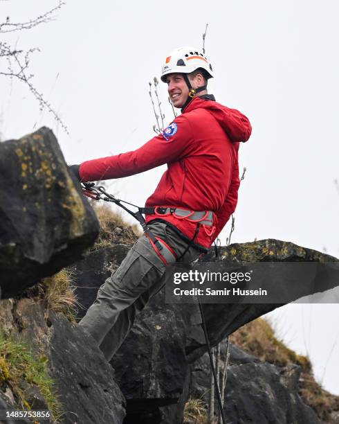 Prince William, Prince of Wales takes part in some abseiling as part of training activities during a visit to Central Beacons Mountain Rescue Team...