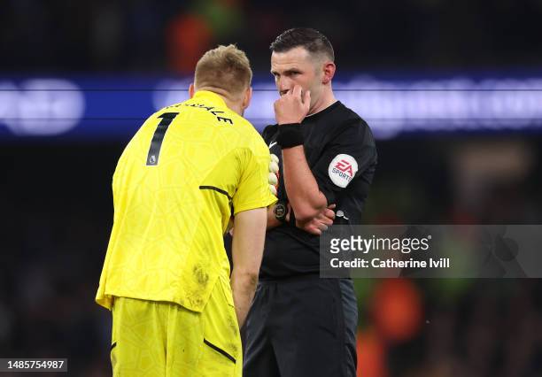 Referee Michael Oliver talks to Aaron Ramsdale of Arsenal during the Premier League match between Manchester City and Arsenal FC at Etihad Stadium on...