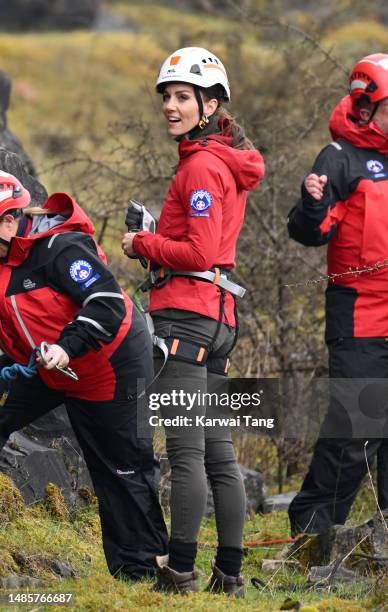 Catherine, Princess of Wales takes part in abseiling as part of training activities during a visit to Central Beacons Mountain Rescue Team during a 2...