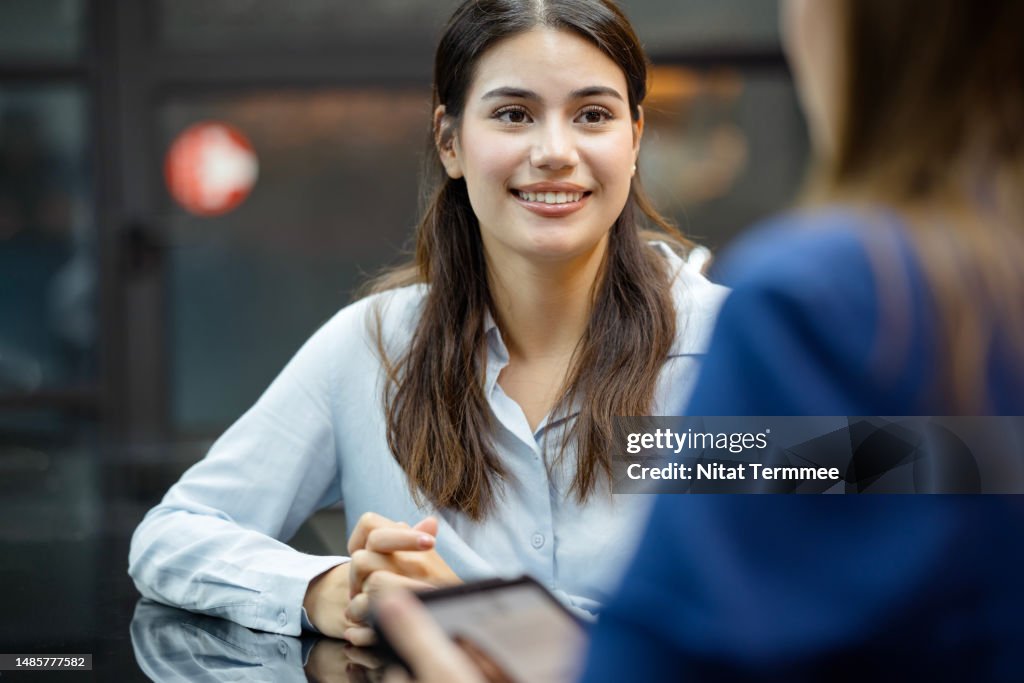 Determine Earning Power and Professional Growth Opportunities. A new female employee on a job interview final round with an HR officer in a business office.