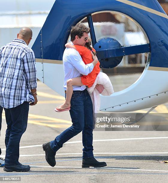 Tom Cruise and Suri Cruise leave Manhattan by helicopter at the West Side Heliport on July 18, 2012 in New York City.