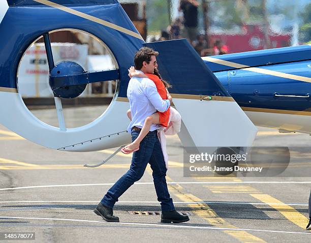 Tom Cruise and Suri Cruise leave Manhattan by helicopter at the West Side Heliport on July 18, 2012 in New York City.