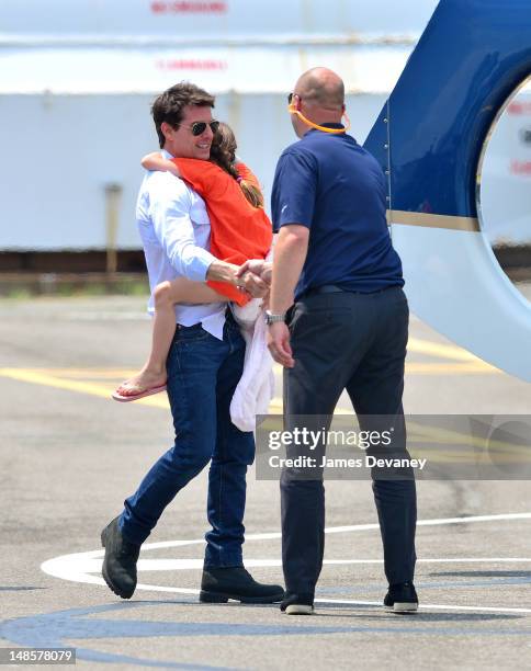 Tom Cruise and Suri Cruise leave Manhattan by helicopter at the West Side Heliport on July 18, 2012 in New York City.