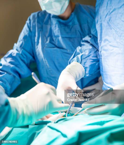 doctor hands performing surgery in hospital - medische artikelen stockfoto's en -beelden