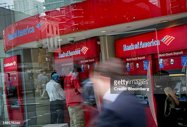 Pedestrians walk past a Bank of America Corp. Branch in New York, U.S., on Wednesday, July 18, 2012. Bank of America Corp., the second- biggest U.S....