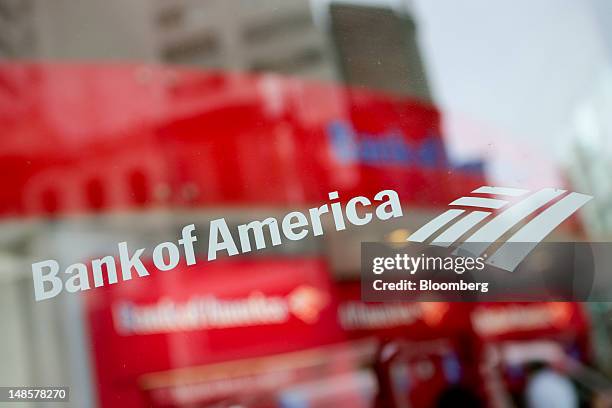 The Bank of America Corp. Logo is displayed on the window of a branch in New York, U.S., on Wednesday, July 18, 2012. Bank of America Corp., the...