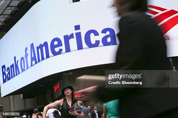 Pedestrians walk past a Bank of America Corp. Branch in New York, U.S., on Wednesday, July 18, 2012. Bank of America Corp., the second- biggest U.S....