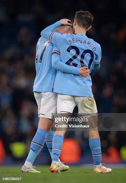 Bernardo Silva of Manchester City embraces team mate Phil Foden during the Premier League match between Manchester City and Arsenal FC at Etihad...