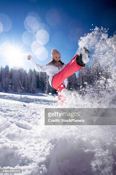 carefree teenage girl playing whit snow on mountain - ski holidays stock pictures, royalty-free photos & images