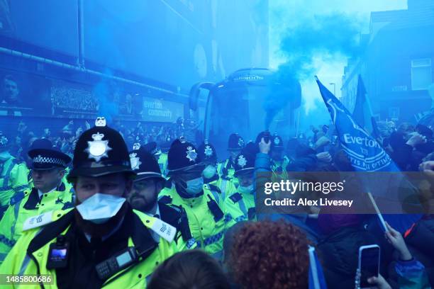 Everton FC fans show their support outside the stadium as the team coach arrives, releasing flares prior to the Premier League match between Everton...