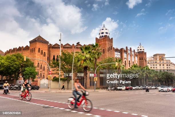 people move own the roads and neighbourhoods of barcelona catalonia spain - plaza de toros barcelona stock pictures, royalty-free photos & images