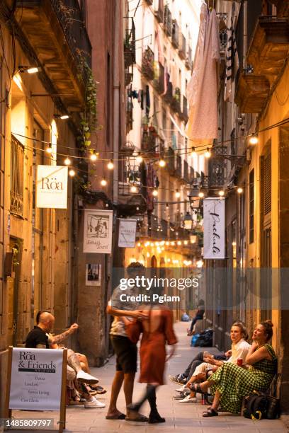 crowds walk by the shops on the narrow streets of barrio gotic in barcelona spain - boardwalk food stock pictures, royalty-free photos & images