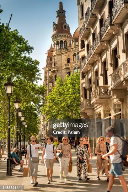 luxury shopping and businesses along the wide streets of the eixample district of barcelona catalonia spain - barcelona shopping stock pictures, royalty-free photos & images