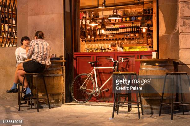 barcelona spain outdoor patio bar night life in the summer - barcelona cafe stock pictures, royalty-free photos & images