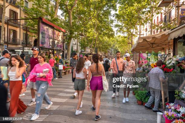 crowds of people walking along la rambla street in barcelona, spain - street promenade stock pictures, royalty-free photos & images