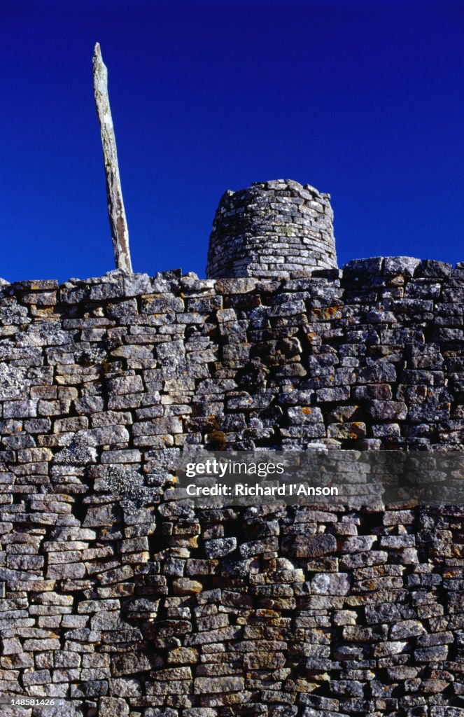 The Hill Complex within the Great Zimbabwe National Monument, the name Zimbabwe is believed to derive from one of two possible Shona origins, dzimba dza mabwe ( great stone houses ) or dzimba woya ( esteemed houses )