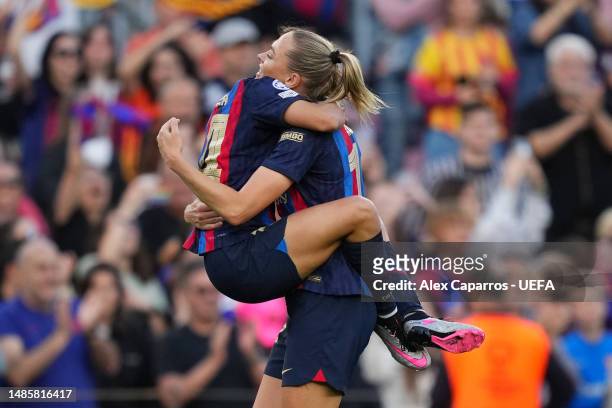 Aitana Bonmati and Fridolina Rolfoe celebrate the team's first goal scored by teammate Caroline Graham Hansen of FC Barcelona during the UEFA Women's...