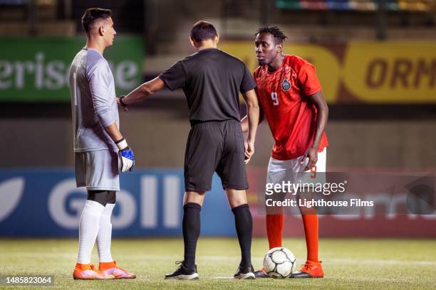 referee prepares professional soccer players for a pentalty shootout - penalty spot football stock pictures, royalty-free photos & images