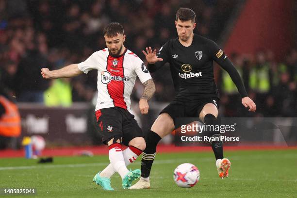 Adam Armstrong of Southampton battles for possession with Chris Mepham of AFC Bournemouth during the Premier League match between Southampton FC and...