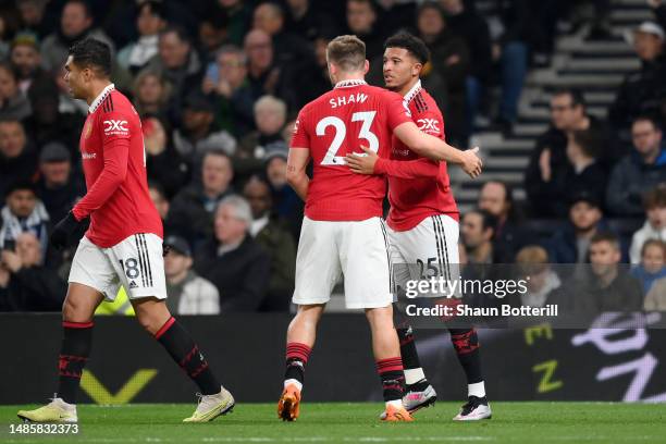 Jadon Sancho of Manchester United celebrates with Luke Shaw after scoring the team's first goal during the Premier League match between Tottenham...