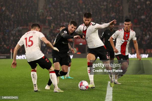 Chris Mepham of AFC Bournemouth is tackled by Duje Caleta-Car of Southampton during the Premier League match between Southampton FC and AFC...