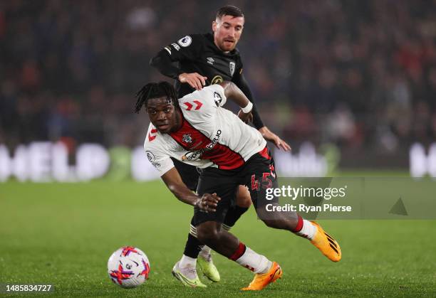 Romeo Lavia of Southampton is put under pressure by Joe Rothwell of AFC Bournemouth during the Premier League match between Southampton FC and AFC...