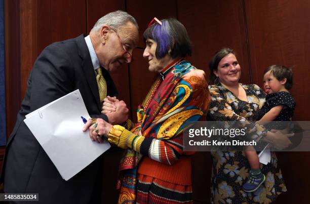 Senate Majority Leader Charles Schumer greets Rep. Rosa DeLauro as Tiffany Nelms holds her son Ruben during an event to reintroduce the Child Care...