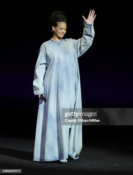 Rihanna waves onstage as she promotes the upcoming film "The Smurfs Movie" during the Paramount Pictures presentation during CinemaCon, the official...