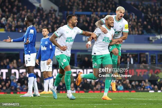 Joelinton of Newcastle United celebrates with teammates Callum Wilson and Bruno Guimaraes after scoring the team's second goal during the Premier...