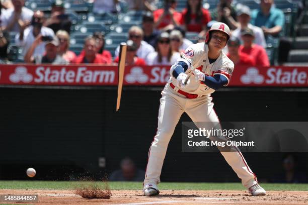 Shohei Ohtani of the Los Angeles Angels breaks his bat hitting in the first inning against the Oakland Athletics at Angel Stadium of Anaheim on April...