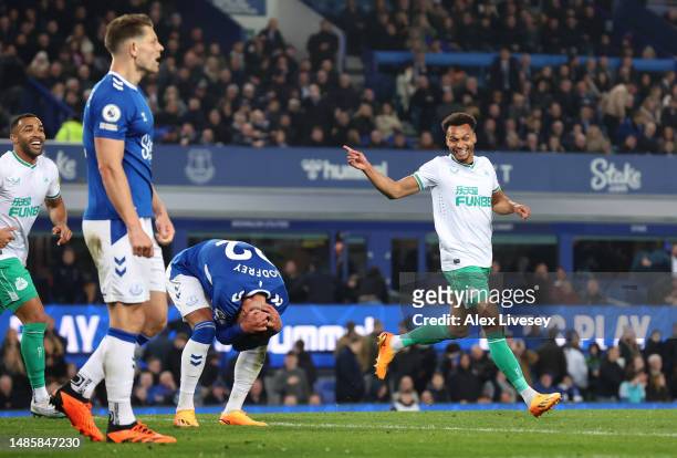 Jacob Murphy of Newcastle United celebrates after scoring the team's fourth goal whilst Ben Godfrey of Everton looks dejected during the Premier...
