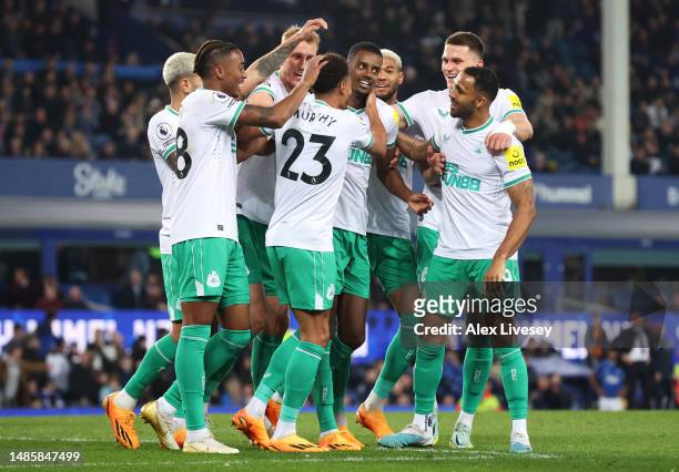 Jacob Murphy of Newcastle United celebrates with teammates after scoring the team's fourth goal during the Premier League match between Everton FC...