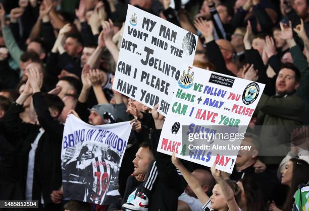 Fans of Newcastle United are seen holding up signs asking for shirts following the Premier League match between Everton FC and Newcastle United at...