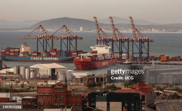 Cape Town South Africa, Container ship berthing alongside the container terminal with assistance from tugs.