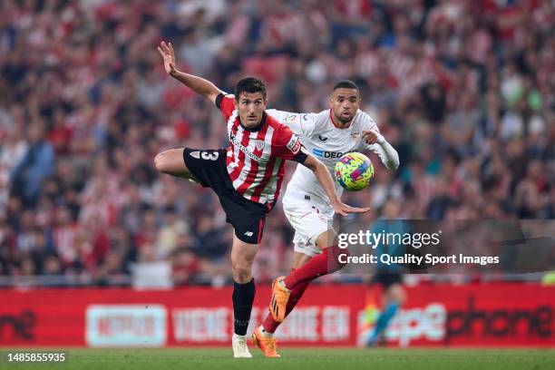 Dani Vivian of Athletic Club compete for the ball with Youssef En-Nesyri of Sevilla FC during the LaLiga Santander match between Athletic Club and...
