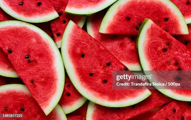 a large number of cut slices of watermelon - watermelon stock pictures, royalty-free photos & images