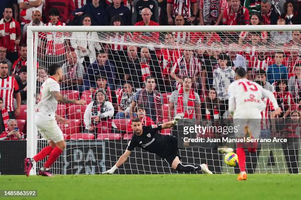 Lucas Ocampos of Sevilla FC scores the team's first goal from a penalty kick past Unai Simon of Athletic Club during the LaLiga Santander match...