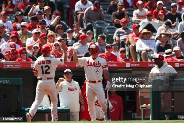 Hunter Renfroe of the Los Angeles Angels celebrates with teammate Mike Trout after he scores in the fifth inning against the Oakland Athletics at...