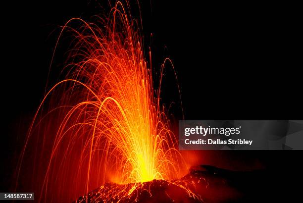 explosive eruption of stromboli volcano at night. - eruption stock-fotos und bilder