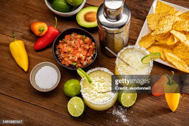 margarita glasses on a retro wood background - tequila tasting stock pictures, royalty-free photos & images