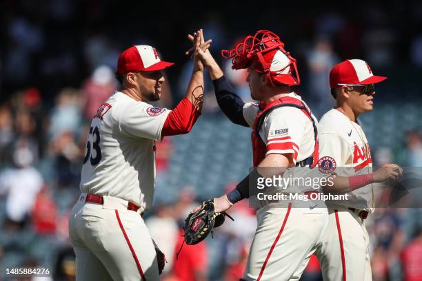 Carlos Estevez of the Los Angeles Angels and teammate Chad Wallach celebrate after defeating the Oakland Athletics at Angel Stadium of Anaheim on...