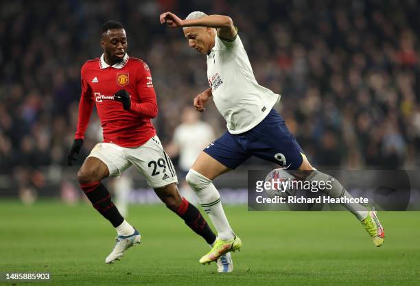 Richarlison of Tottenham Hotspur is put under pressure by Aaron Wan-Bissaka of Manchester United during the Premier League match between Tottenham...
