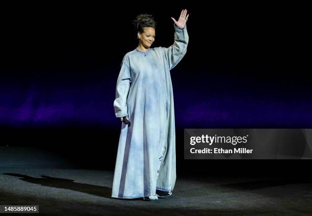 Rihanna waves onstage as she promotes the upcoming film "The Smurfs Movie" during the Paramount Pictures presentation during CinemaCon, the official...