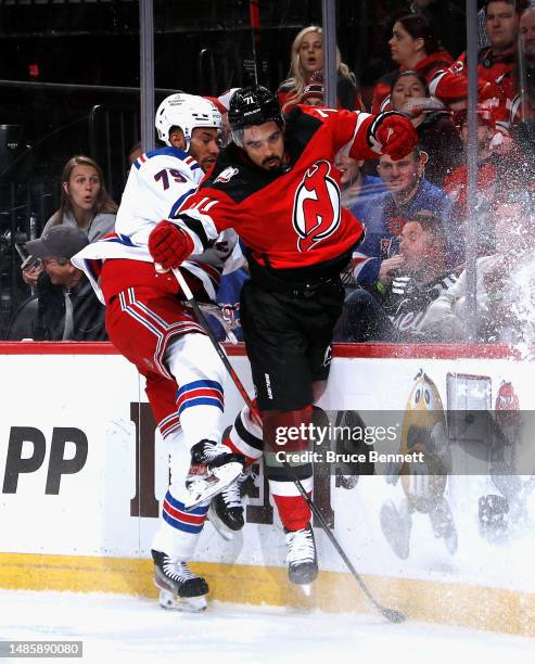 Jonas Siegenthaler of the New Jersey Devils and K'Andre Miller of the New York Rangers collide during the first period in Game Five of the First...