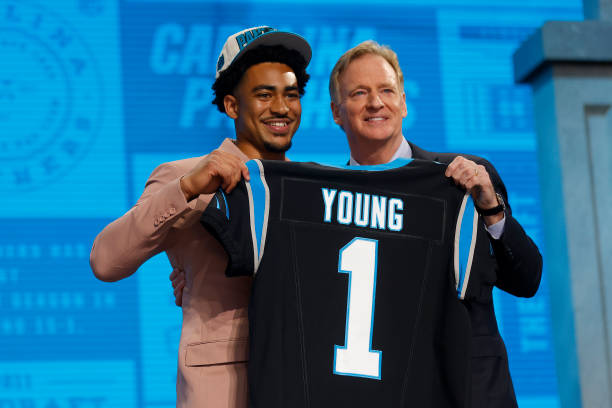 Bryce Young poses with NFL Commissioner Roger Goodell after being selected first overall by the Carolina Panthers during the first round of the 2023...